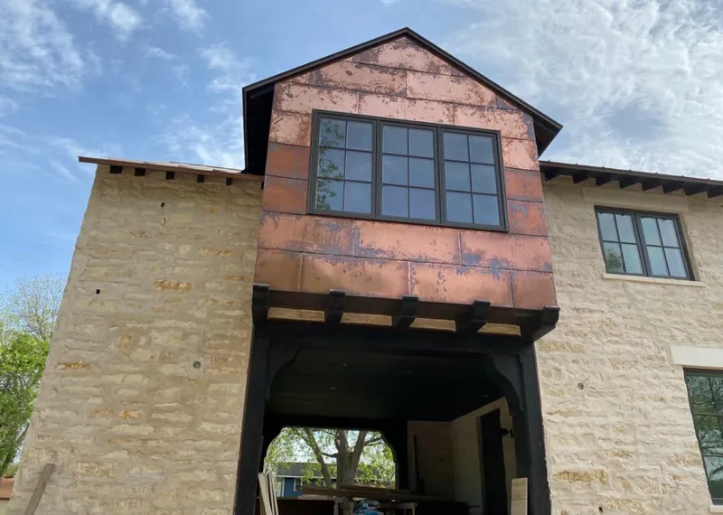 Copper metal panel facade on a stone building for Skylight Installation in Rayne
