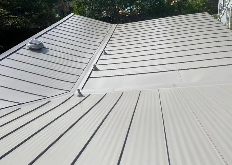 Solar attic fan installed on a metal roof for Roof Ventilation in Rayne